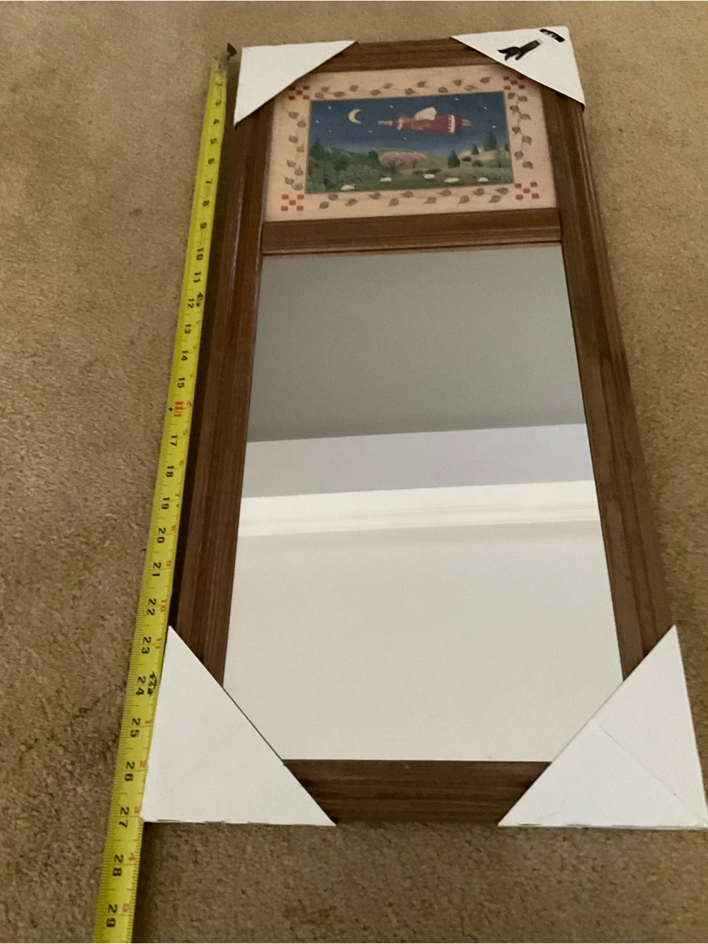 Vintage wood-framed trumeau mirror with a folk art print